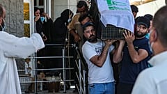 مشيعون يحملون نعش ريهام يعقوب المغطى بالعلم خلال جنازتها في البصرة، العراق