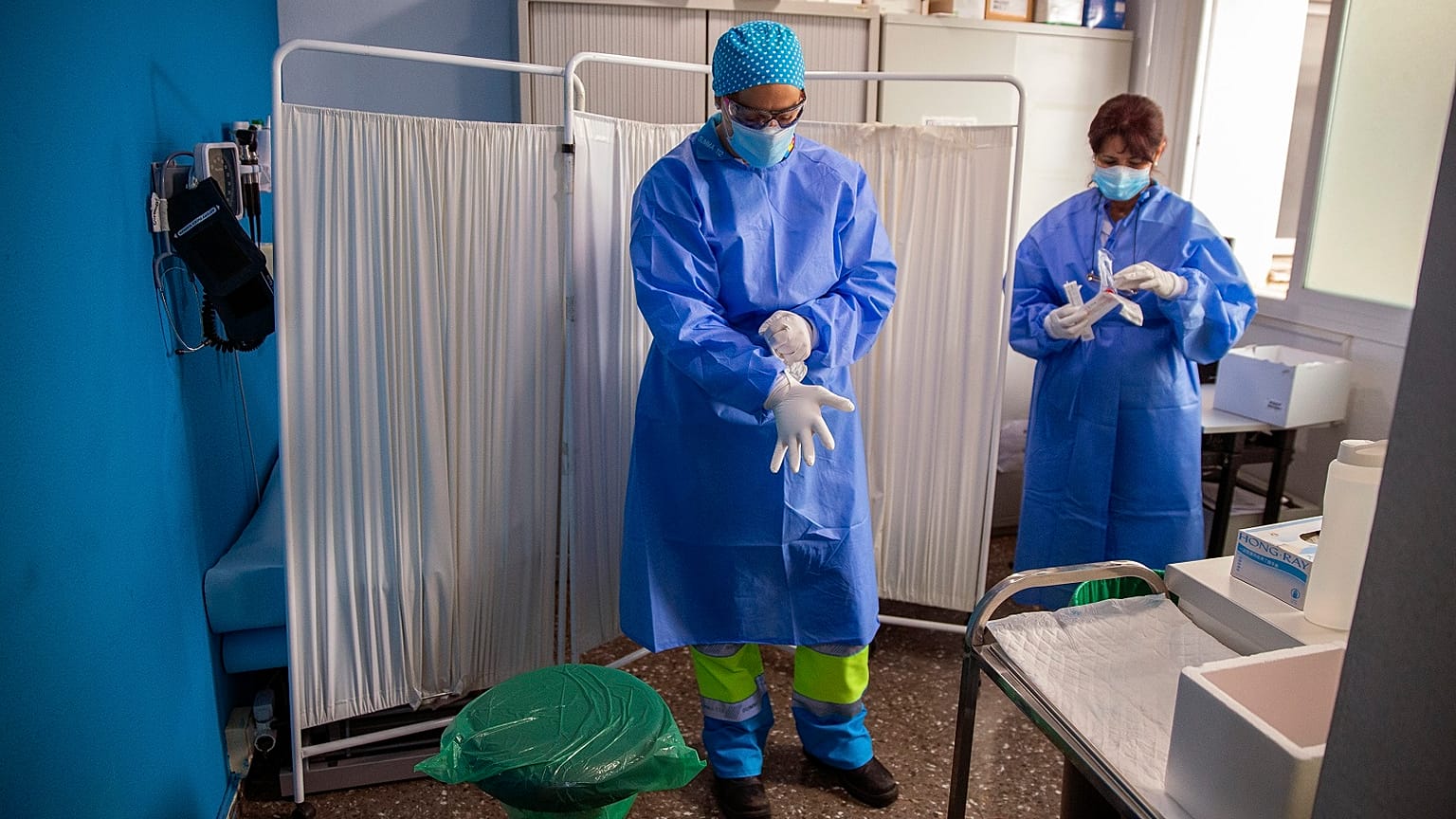 Health workers get ready to take samples for PCR tests for the COVID-19 at a medical centre in Madrid.