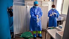 Health workers get ready to take samples for PCR tests for the COVID-19 at a medical centre in Madrid.