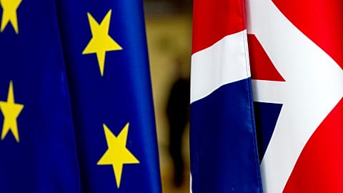 In this file photo dated Tuesday, January 28, 2020, the EU and UK flags are seen inside the atrium at the Europa building in Brussels. 