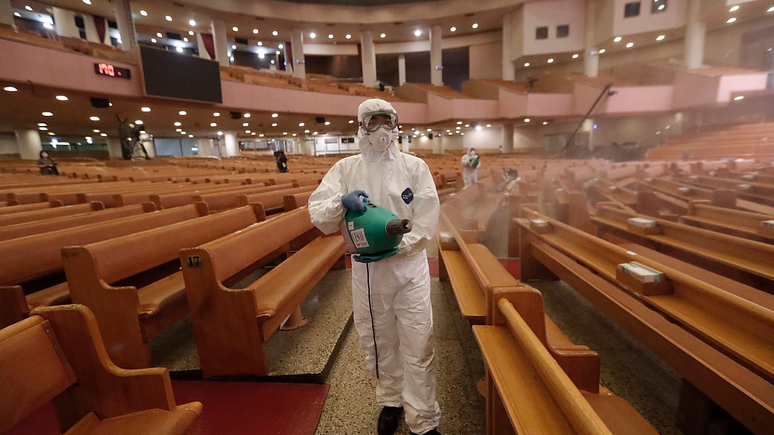 A public official disinfects as a precaution against the coronavirus at the Yoido Full Gospel Church in Seoul, South Korea, Friday, Aug. 21, 2020