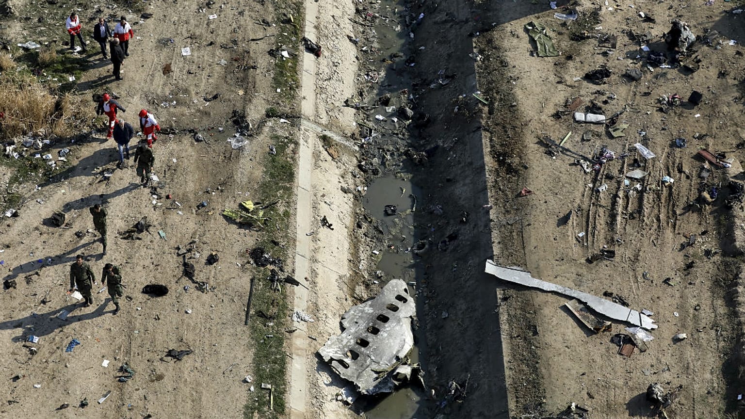 Rescue workers search the scene where a Ukrainian plane crashed in Shahedshahr, southwest of the capital Tehran, Iran