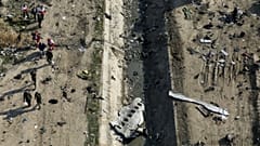 Rescue workers search the scene where a Ukrainian plane crashed in Shahedshahr, southwest of the capital Tehran, Iran