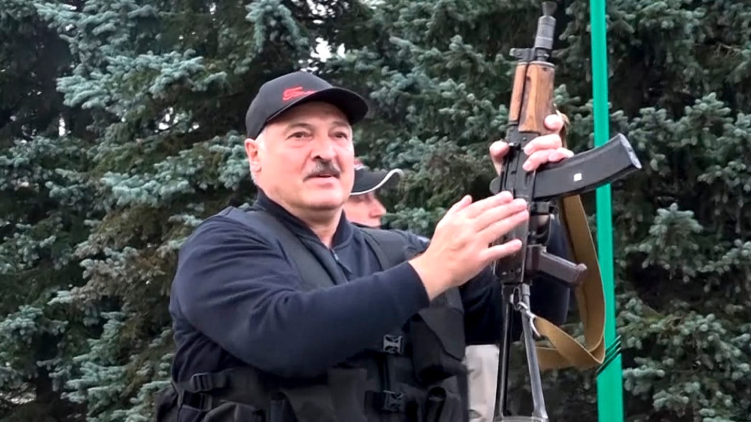 Video provided by state TV shows Belarus President Alexander Lukashenko armed with a Kalashnikov-type rifle on Sunday.