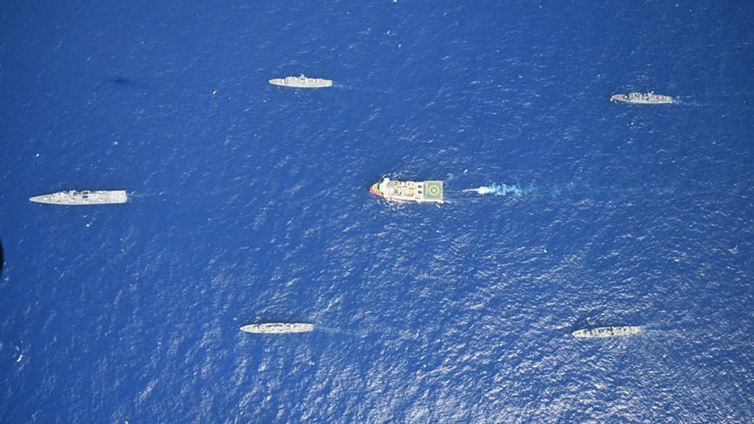 Turkey's research vessel, Oruc Reis, in red and white, is surrounded by Turkish navy vessels as it was heading in the west of Antalya on the Mediterranean