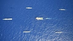 Turkey's research vessel, Oruc Reis, in red and white, is surrounded by Turkish navy vessels as it was heading in the west of Antalya on the Mediterranean