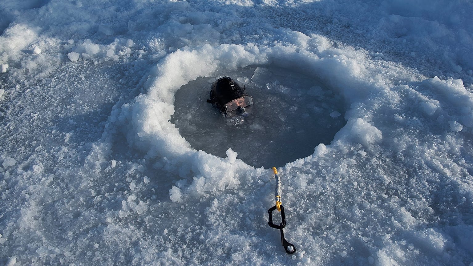 A US Navy diver helping a team from the Arctic Submarine Laboratory recover a torpedo fired from the nuclear-powered fast-attack submarine USS Hartford. Beaufort Sea, Alaska