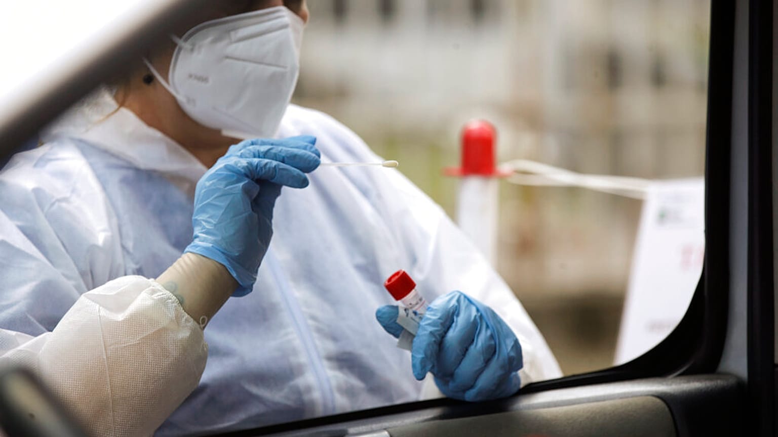 Trabajadora sanitaria realizando pruebas a turistas que regresan a Italia