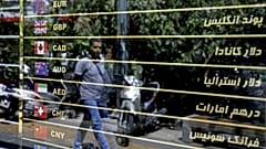 Various currencies are displayed without the going rate on a money exchange shop window in downtown Tehran, Iran