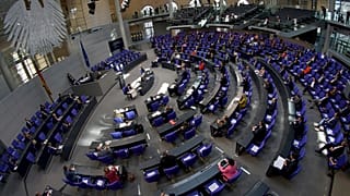 Lawmakers attend a meeting of the German federal parliament, or Bundestag, at the Reichstag building in Berlin.