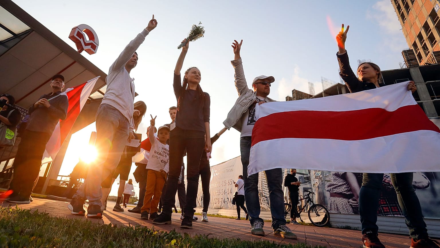 Protesters in Minsk on August 21 after Belarus' authorities detained a leader of striking factory workers and threatened protesters with criminal charges 