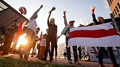 Protesters in Minsk on August 21 after Belarus' authorities detained a leader of striking factory workers and threatened protesters with criminal charges 