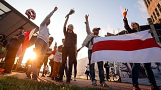 Protesters in Minsk on August 21 after Belarus' authorities detained a leader of striking factory workers and threatened protesters with criminal charges 