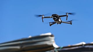 A DJI Mavic 2 drone is flown by field property specialist Sam Ellenburg of Grange/Integrity Insurance as he surveys damage at Wired Production Group.