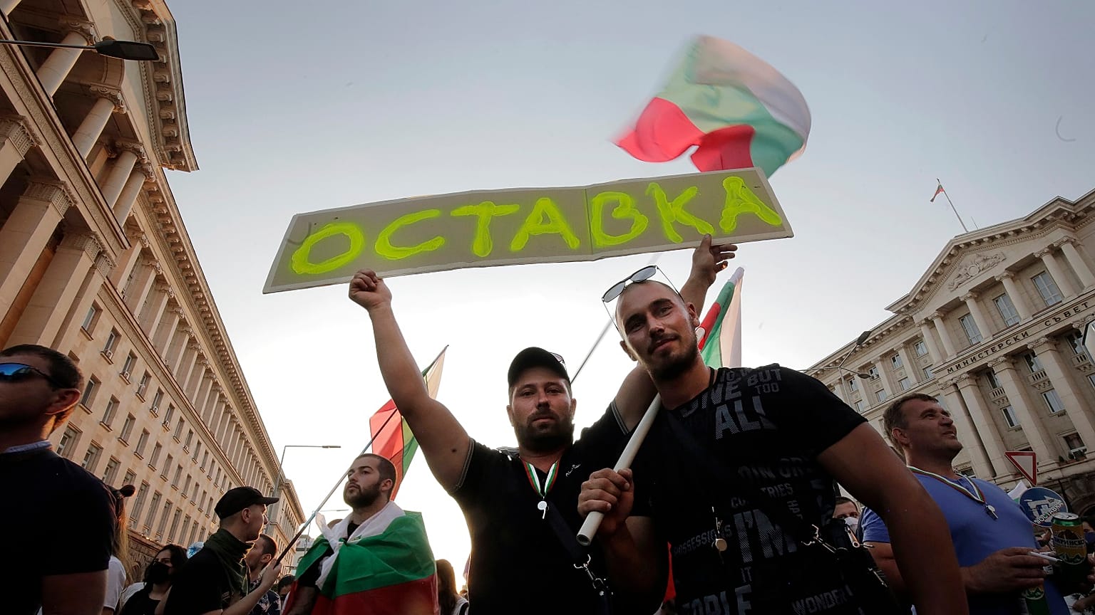 Protesters carry a poster reading "Resignation" during a mass protest in the capital, Sofia.