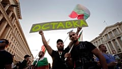Protesters carry a poster reading "Resignation" during a mass protest in the capital, Sofia.