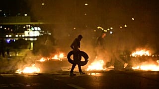Demonstrators burn tyres during clashes with police in the Rosengard neighbourhood of Malmo, Sweden, on August 28, 2020