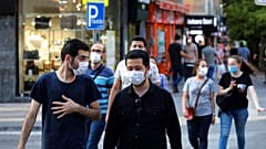 People wearing face masks to protect against the spread of coronavirus, walk in Ankara