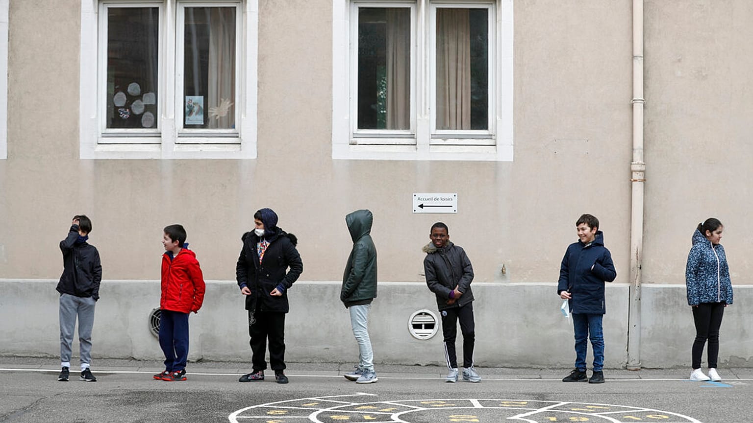 In this Thursday, May 14, 2020 file photo, schoolchildren wait in line to go back in their classroom at the Sainte Aurelie primary school of Strasbourg.