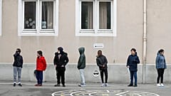 In this Thursday, May 14, 2020 file photo, schoolchildren wait in line to go back in their classroom at the Sainte Aurelie primary school of Strasbourg.