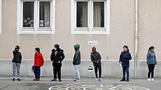 In this Thursday, May 14, 2020 file photo, schoolchildren wait in line to go back in their classroom at the Sainte Aurelie primary school of Strasbourg.