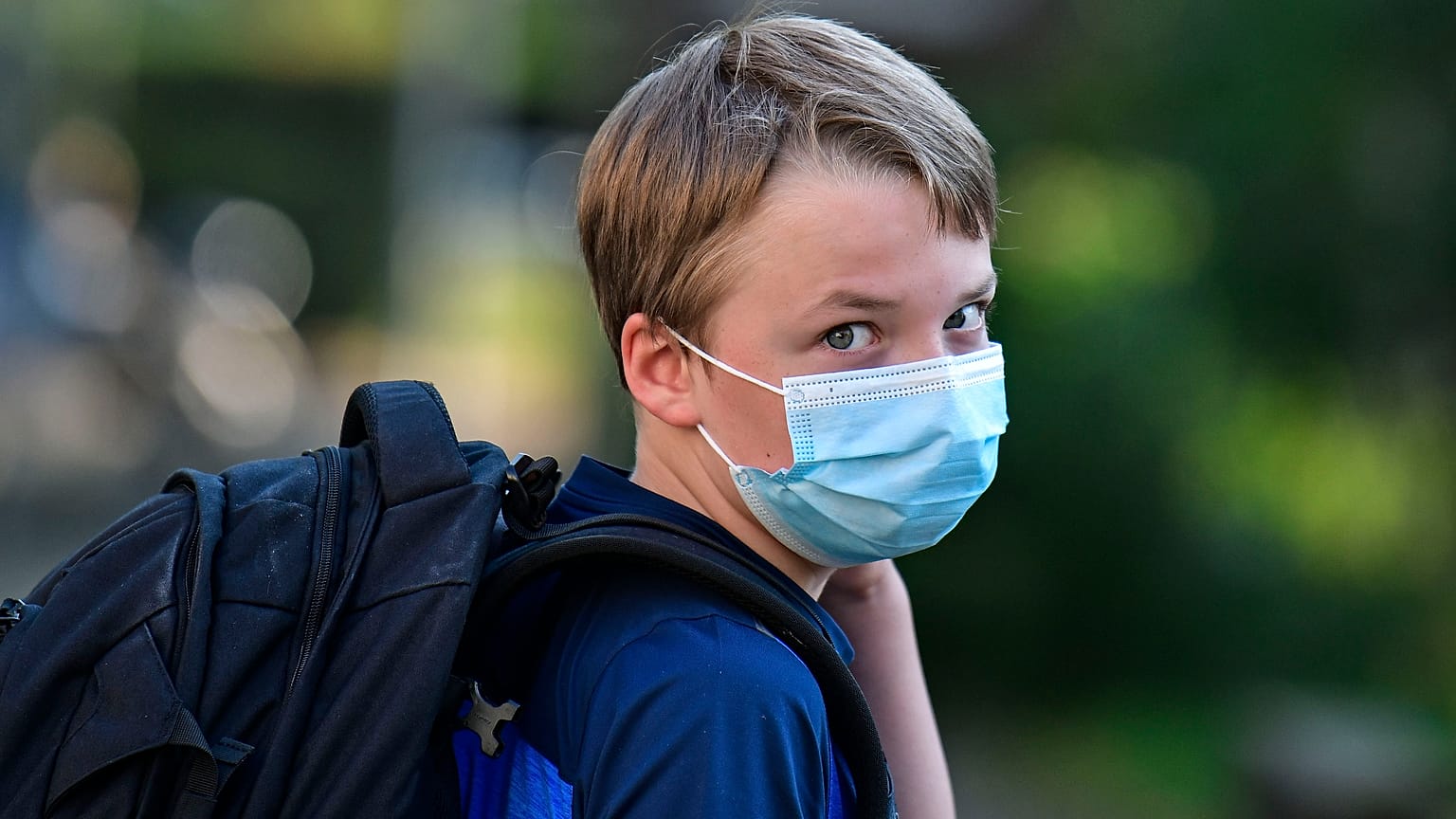 A child in Gelsenkirchen, Germany, returns to school wearing a mask. Wednesday, Aug. 12, 2020.