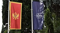 In this photo taken Monday, Nov. 11, 2019, the Montenegro, left, and NATO flags wave in front of the Montenegrin Defense Ministry in Podgorica, Montenegro.