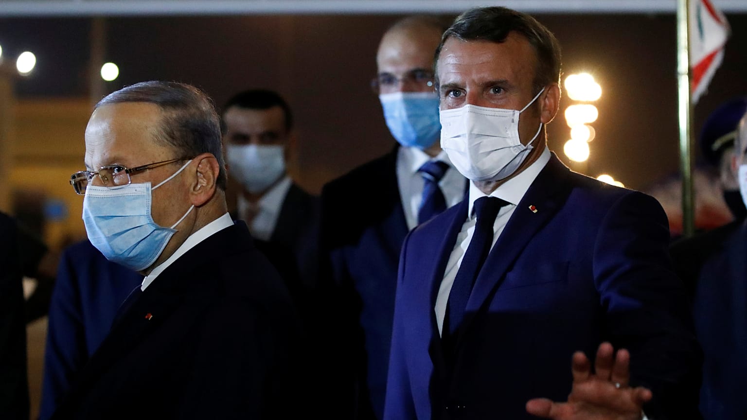 French President Emmanuel Macron, gestures before meeting with Lebanese President Michel Aoun, left, at Beirut International airport, Monday, Aug. 31, 2020