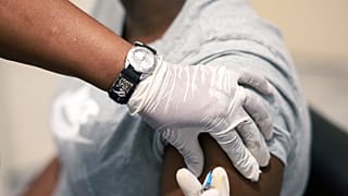Sisi Ndebele, receives a seasonal influenza vaccine from a nurse at a local pharmacy clinic in Johannesburg, South Africa on Friday, April 24, 2020.