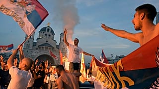 Opposition supporters celebrate the election results outside the Serbian Orthodox Church of Christ's Resurrection in Podgorica, Montenegro.