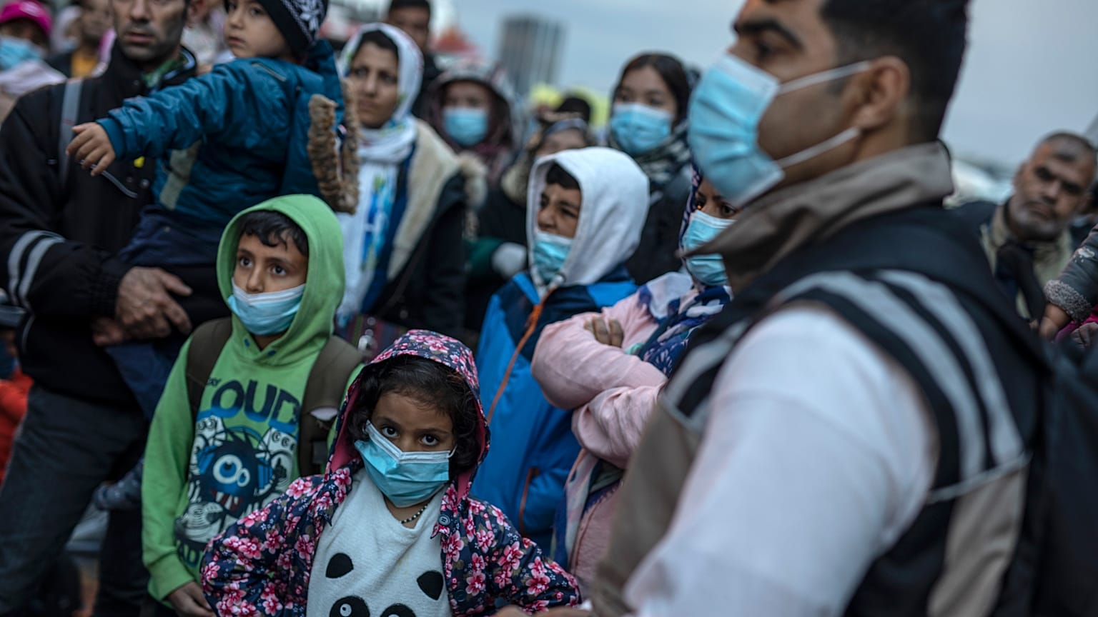 Refugees and migrants wearing masks to prevent the spread off the coronavirus, after their arrival at the port of Piraeus , near Athens, on May 4, 2020.