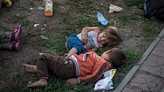 Syrian children sleep in a park in Belgrade, Serbia