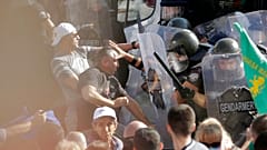 Police scuffle with protesters during rally in front of the new National Assembly building, demanding government resignation in Sofia on Wednesday, Sept. 2, 2020. 