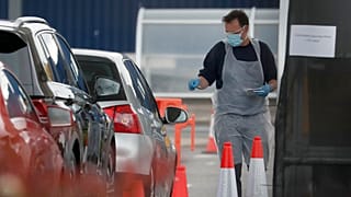 Staff work at a the COVID-19 testing facility at Ikea near the Wembley stadium in London, Wednesday, April 29, 2020. 