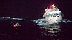 In this photo released by the 10th Regional Japan Coast Guard Headquarters, a Filipino crewmember of a Panamanian cargo ship is rescued by Japanese Coast Guard members.