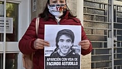 Cristina Castro, madre del joven muerto, muestra un cartel con su foto