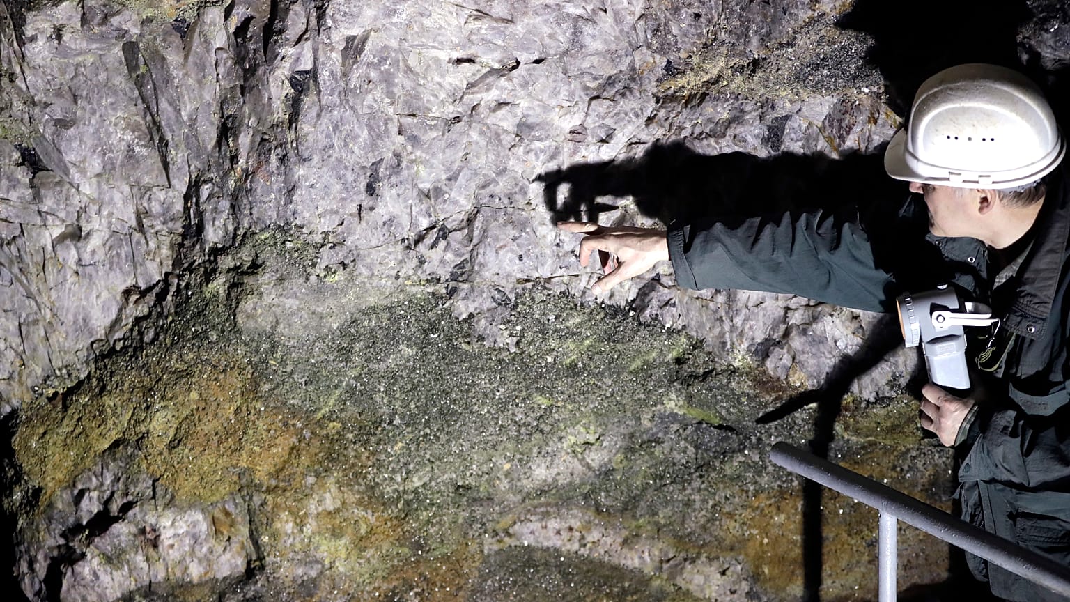 One of the four founders of Geomet company, points at ore containing lithium inside a former mine located at the border with Germany near Cinovec, Czech Republic.