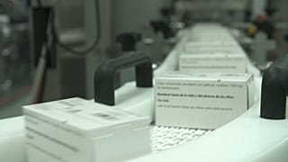 Medication labels are added on a production line before being shipped to European pharmacies.