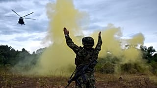 A soldier in Colombia working to catch those responsible for illegal deforestation.