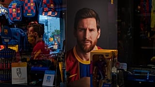A poster with the face of Barcelona soccer player Lionel Messi is displayed at a FC Barcelona store in Barcelona, Spain.