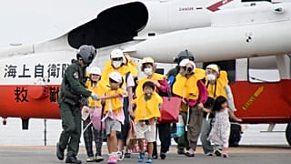 Residents arrive at a heliport in Kagoshima, southern Japan Friday, Sept. 4, 2020, to take refuge ahead of a powerful typhoon.
