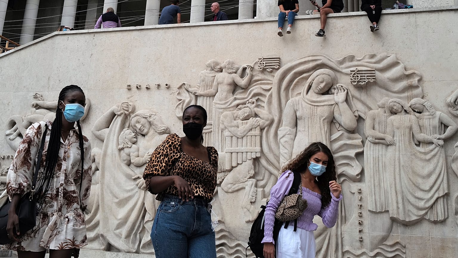 Women walk at The Palais de Tokyo Museum wearing a protective face mask as a precaution against the coronavirus in Paris, Saturday, Sept. 5, 2020.