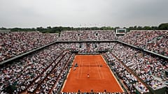 In this June 10, 2018 file photo, the crowd watch Austria's Dominic Thiem serving to Spain's Rafael Nadal during the men's final match of the French Open.