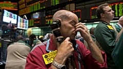 Traders work in the oil options pit at the New York Mercantile Exchange