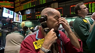 Traders work in the oil options pit at the New York Mercantile Exchange