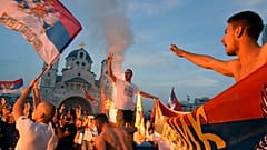 Opposition supporters celebrate after the parliamentary elections in front of the Serbian Orthodox Church of Christ's Resurrection in Podgorica, Montenegro, Monday, Aug. 31