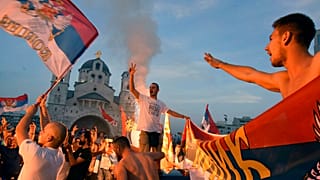 Opposition supporters celebrate after the parliamentary elections in front of the Serbian Orthodox Church of Christ's Resurrection in Podgorica, Montenegro, Monday, Aug. 31