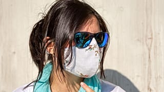 إمرأة ترتدي كمامة من القماش