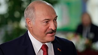 Belarusian President Alexander Lukashenko smiles after voting at a polling station during parliamentary elections, in Minsk, Belarus
