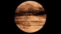 The full moon rises beyond wispy clouds, Sunday, Aug. 2, 2020, in Kansas City, Mo, United States.